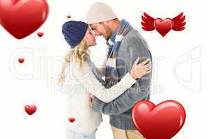 Composite image of attractive couple in winter fashion hugging