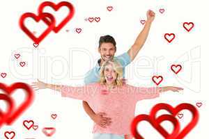 Composite image of attractive couple smiling and cheering