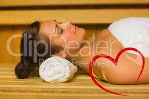 Composite image of peaceful brunette relaxing in a sauna