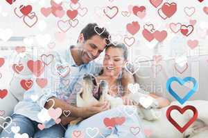 Composite image of happy couple petting their yellow labrador on