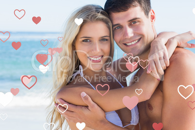 Composite image of beautiful couple hugging and smiling