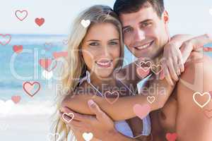 Composite image of beautiful couple hugging and smiling