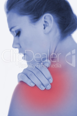 Upset woman suffering from shoulder pain