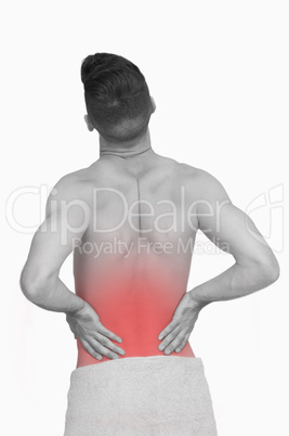 Rear view of shirtless man with back pain