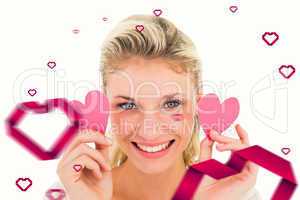 Composite image of attractive young blonde holding little hearts