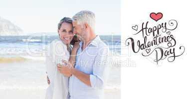 Composite image of happy couple hugging on the beach woman looki