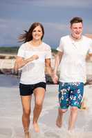 happy young couple on the beach in summer holiday love