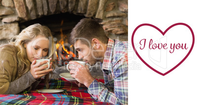 Composite image of romantic couple drinking tea in front of lit