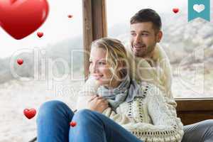 Composite image of couple in winter wear looking out through cab