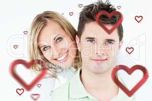 Composite image of portrait of a young happy couple standing aga
