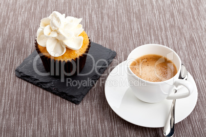 tasty sweet cupcake and hot aromatic espresso coffee