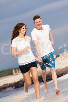 happy young couple on the beach in summer holiday love