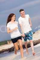happy young couple on the beach in summer holiday love