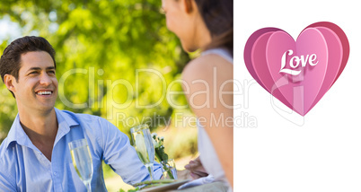 Composite image of couple with champagne flutes sitting at an ou