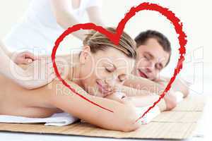 Composite image of affectionate couple having a back massage wit