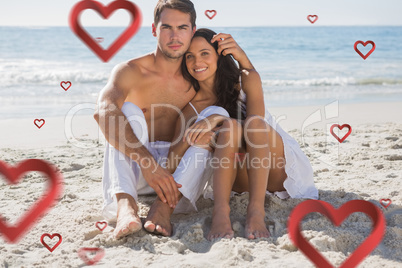 Composite image of cuddling couple smiling at camera