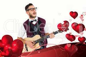 Composite image of geeky hipster playing guitar and singing