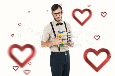 Composite image of geeky hipster holding an abacus