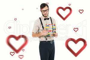Composite image of geeky hipster holding an abacus