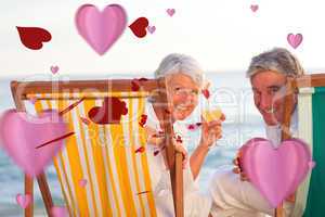 Composite image of senior couple drinking a cocktail