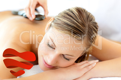 Composite image of attractive woman having a massage