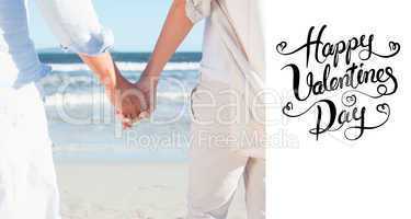 Composite image of couple on the beach looking out to sea holdin