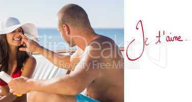 Composite image of handsome man applying sun cream on his girlfr