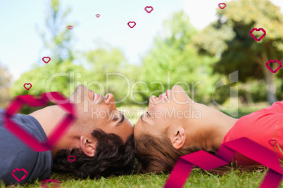 Composite image of two smiling friends with their eyes closed wh