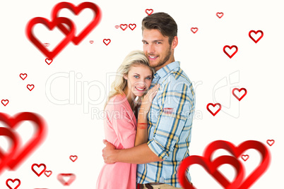 Composite image of attractive couple embracing and smiling at ca