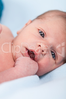 Small infant wrapped in knitted fabric