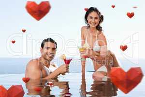 Composite image of cheerful couple having cocktails in the pool