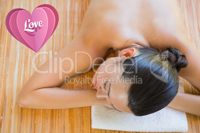 Composite image of content brunette relaxing on massage table
