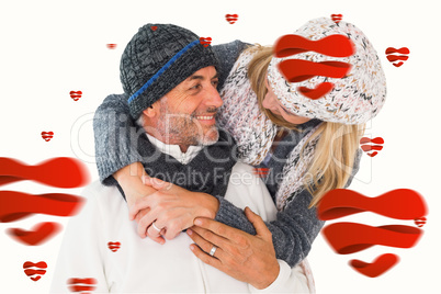 Composite image of happy couple in winter fashion embracing