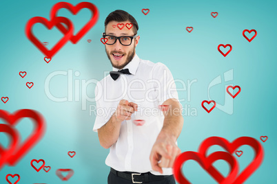 Composite image of geeky hipster pointing at camera