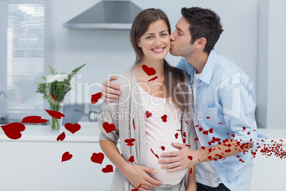 Composite image of man kissing his pregnant wife