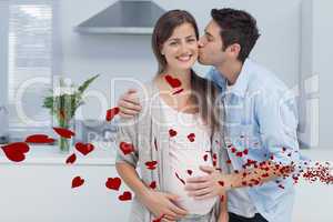 Composite image of man kissing his pregnant wife