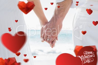 Composite image of bride and groom holding hands close up