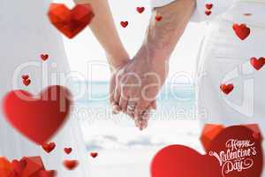 Composite image of bride and groom holding hands close up
