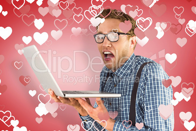 Composite image of geeky businessman using his laptop