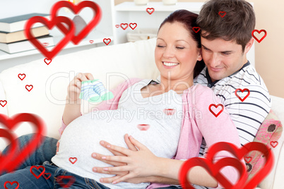 Composite image of portrait of a happy pregnant woman holding ba