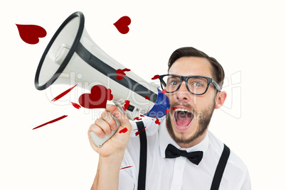 Composite image of geeky businessman shouting through megaphone