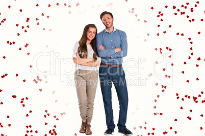 Composite image of smiling young couple with arms crossed