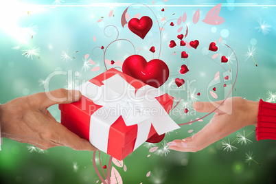 Composite image of couple holding gift