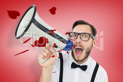 Composite image of geeky businessman shouting through megaphone