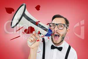 Composite image of geeky businessman shouting through megaphone