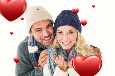 Composite image of attractive couple in winter fashion smiling a