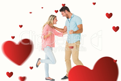 Composite image of attractive couple smiling and cheering