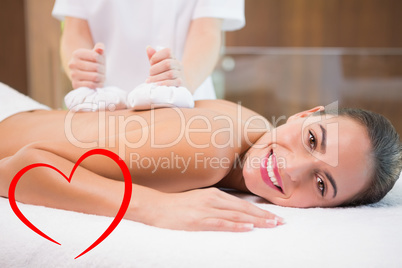 Composite image of attractive woman receiving treatment at spa c