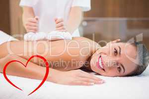 Composite image of attractive woman receiving treatment at spa c