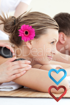 Composite image of cheerful young couple enjoying a spa treatmen